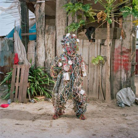 Artist Falonne Mambu poses in her electric wires costume in Limete district, Kinshasa. Through her performance art, she raises issues about social development in the DRC. 