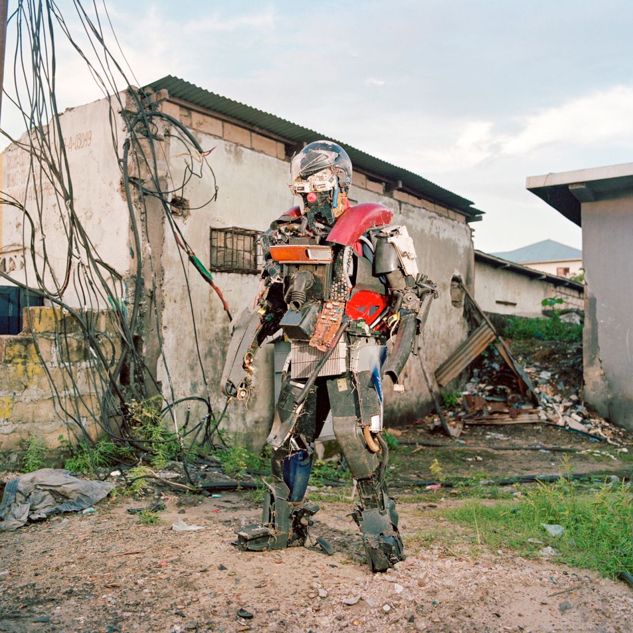 Congolese artist Jean Precy Numbi Samba, also known by his artist name Robot Kimbalambala posing in his robot sapiens costume made from car's spare parts,  in Ngiri Ngiri district, Kinshasa ( Democratic Republic of Congo), December 2019. The artist thus denounces the environmental, technological and political issues common to African countries.