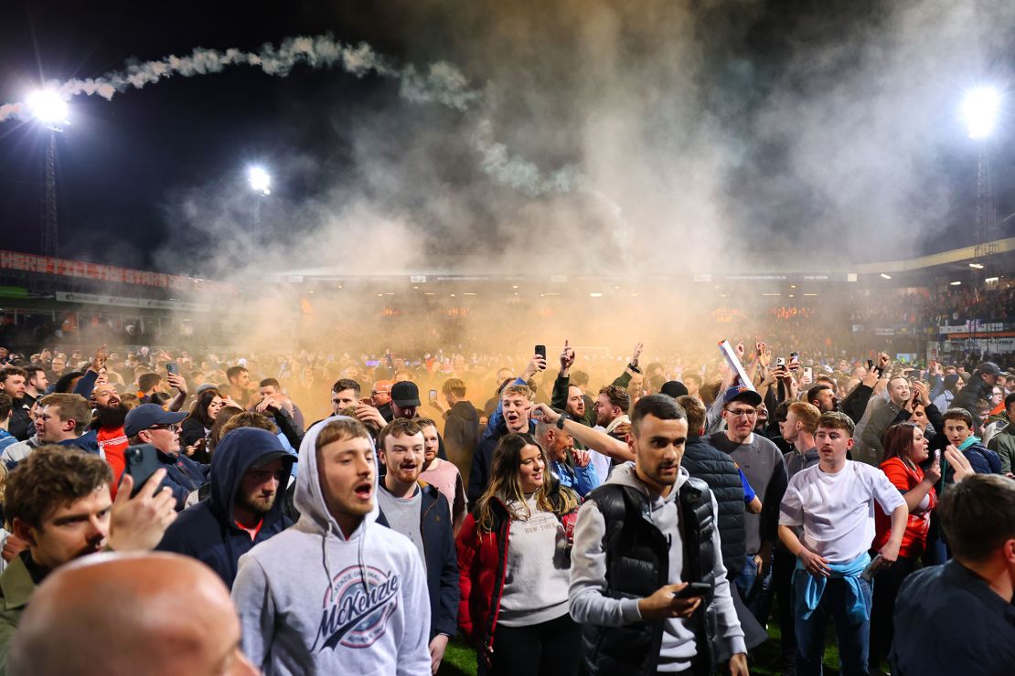 Luton fans celebrate on the pitch after beating Sunderland in the Championship play-off semifinal second leg.