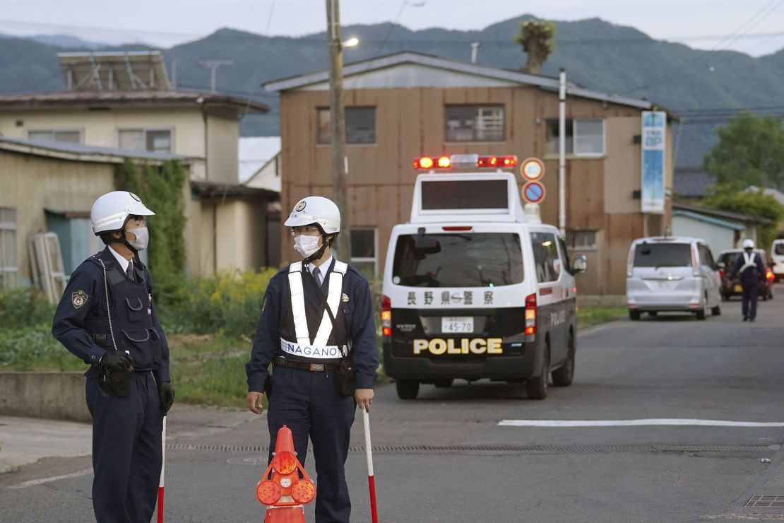 Police officers stand near the scene of the attack. Gun violence in Japan is extremely rare. 