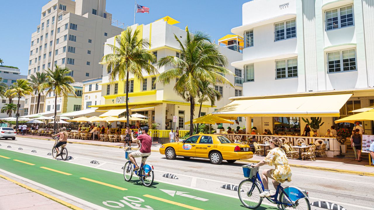 Miami Beach, Florida, Ocean Drive Art Deco District, bike lane bicyclists on citibikes near hotels and taxi cab. (Photo by: Jeffrey Greenberg/Universal Images Group via Getty Images)