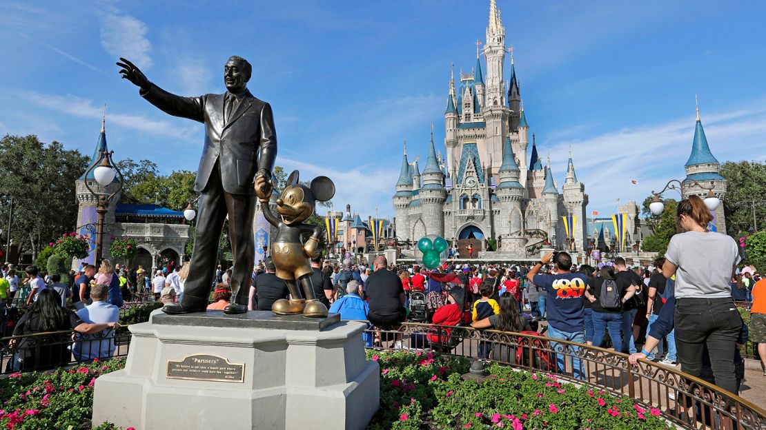 FILE - In this Jan. 9, 2019, photo, guests watch a show near a statue of Walt Disney and Micky Mouse in front of the Cinderella Castle at the Magic Kingdom at Walt Disney World in Lake Buena Vista, part of the Orlando area in Fla. Florida's Republican Gov. Ron DeSantis' decision to punish Disney World, took his fighter mentality to a new level. In retribution for Disney's criticism of a new state law condemned by critics as "Don't Say Gay," DeSantis signed legislation on Friday, April 23, 2022, stripping the theme park of a decades-old special agreement that allowed it to govern itself. (AP Photo/John Raoux, File)
