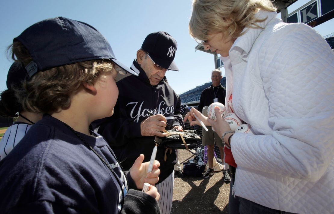 New York Yankees Hall of Fame catcher Yogi Berra signs autographs for special guests of the Yankees before team's spring training baseball game against the Toronto Blue Jays at Steinbrenner Field in Tampa, Fla., in March 2010.