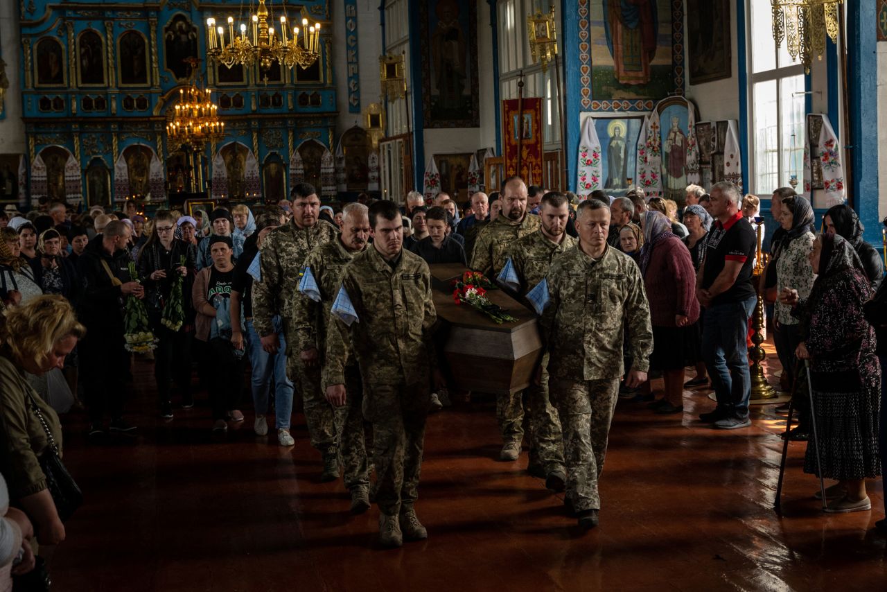 The coffin of Oleksandr Shargorodskyi, a Ukrainian soldier killed in Bakhmut, is carried during his funeral in Trebukhiv, Ukraine, on Sunday, May 21.