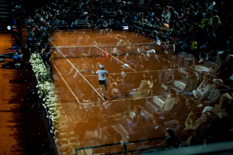 Tennis pro Borna Coric is reflected in a glass barrier as he returns the ball during a match at the Italian Open in Rome on Thursday, May 18.