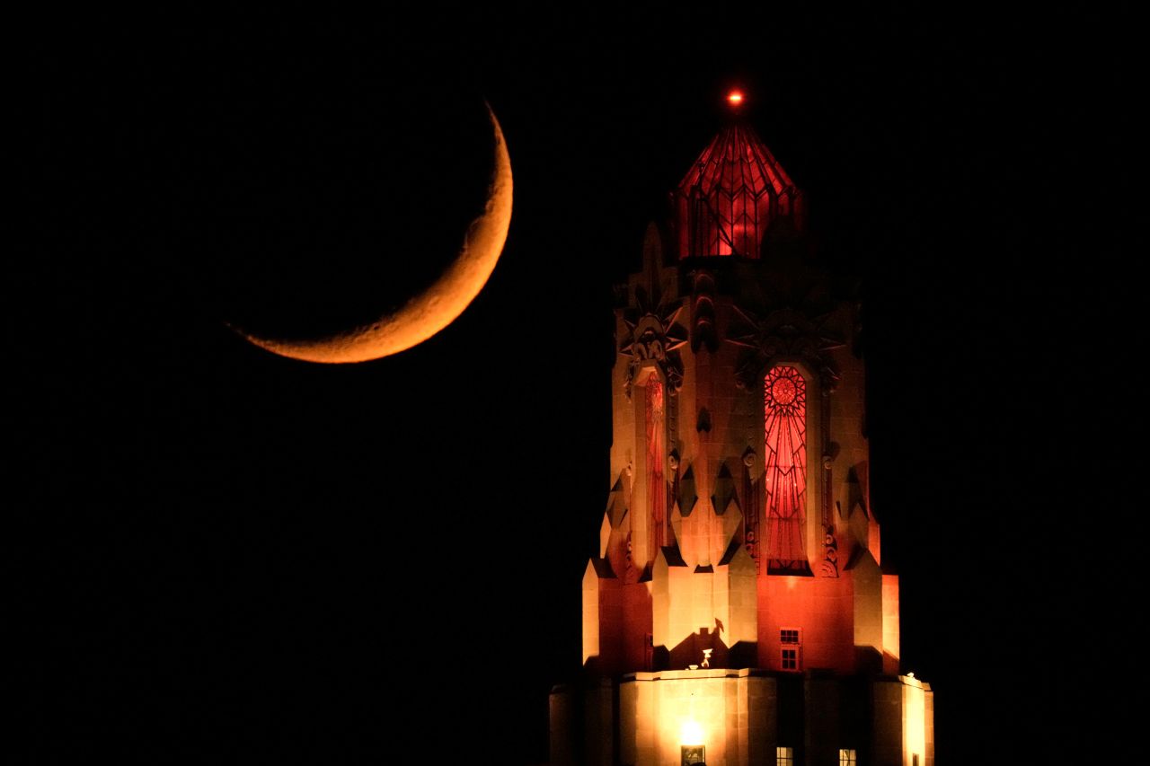 A crescent moon is seen behind the Power and Light Building in Kansas City, Missouri, on Monday, May 22.
