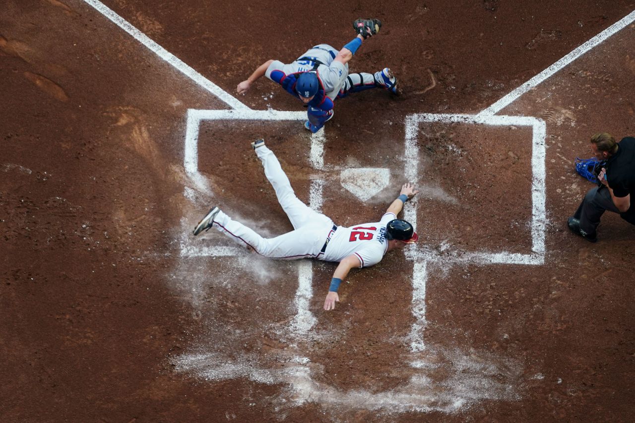The Atlanta Braves' Sean Murphy slides into home, past Los Angeles Dodgers catcher Will Smith, during the first inning of a Major League Baseball game in Atlanta on Tuesday, May 23.