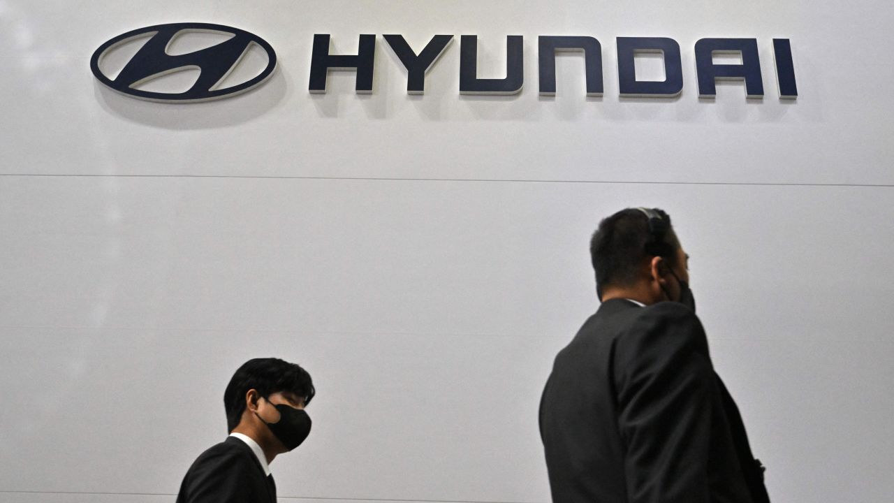Visitors walk past the logo of Hyundai during a press preview of the 2023 Seoul Mobility Show at the KINTEX exhibition hall in Goyang on March 30, 2023.
