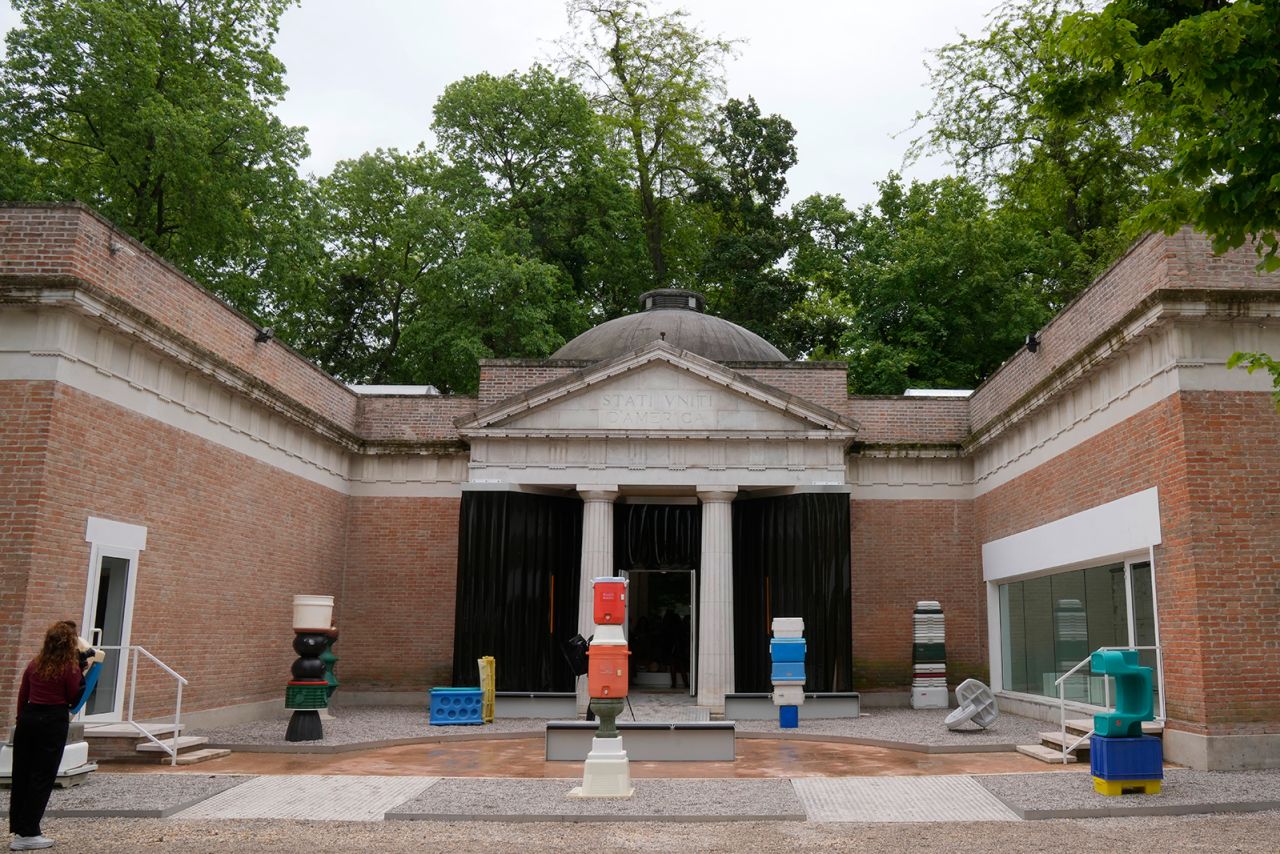 A woman looks at the "Everlasting Plastics" installation at the United States pavilion, at the Biennale International Architecture exhibition, in Venice, Italy, Wednesday, May 17, 2023. The 18th edition of the Biennale International Architecture exhibition will open to the public from Saturday May 20 to Sunday Nov. 26, 2023.