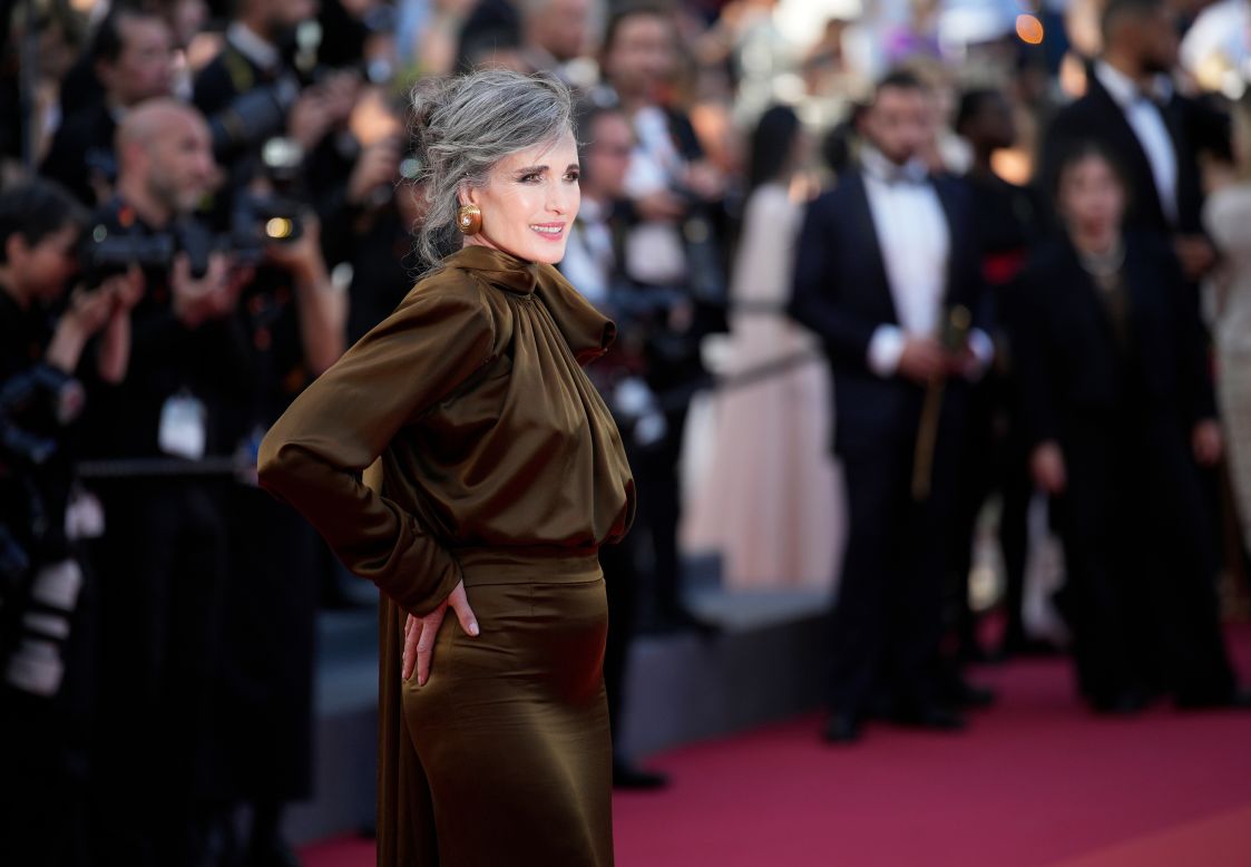 Andie MacDowell wore Saint Laurent for the "Last Summer" red carpet, arriving in a long sleeve khaki-colored blouse and matching silk satin skirt.
