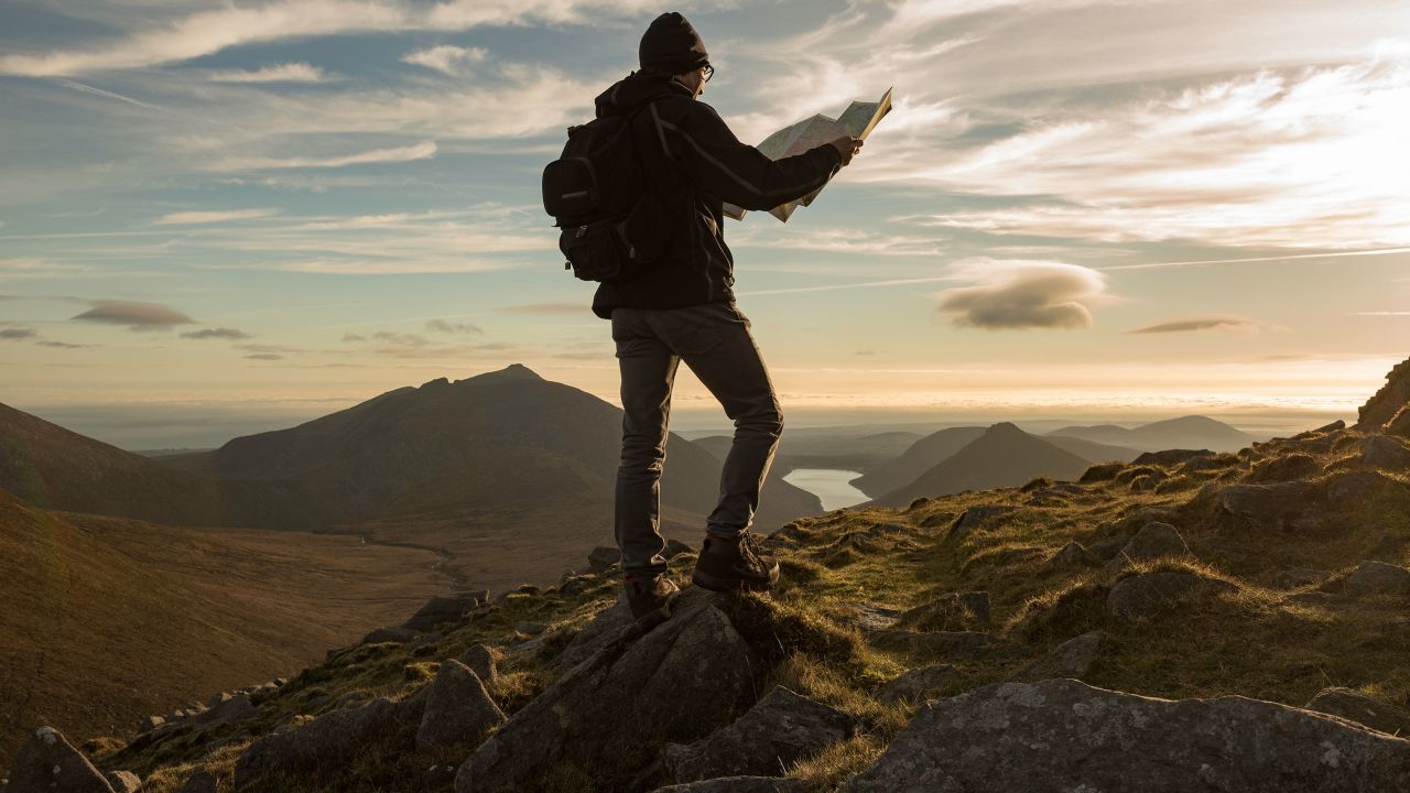 Hiker with map, Morne Mountains, County Down, Northern Ireland