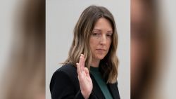 Dr. Caitlin Bernard raises her right hand as she is sworn in Thursday, May 25, 2023, during a hearing in front of the state medical board at the Indiana Government South building in downtown Indianapolis. Bernard is appearing before the board for the final hearing in a complaint filed by Attorney General Todd Rokita saying she violated patient privacy laws and reporting laws.