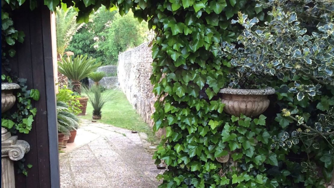 Guests walk through the garden, which is home to a ruined Roman villa.