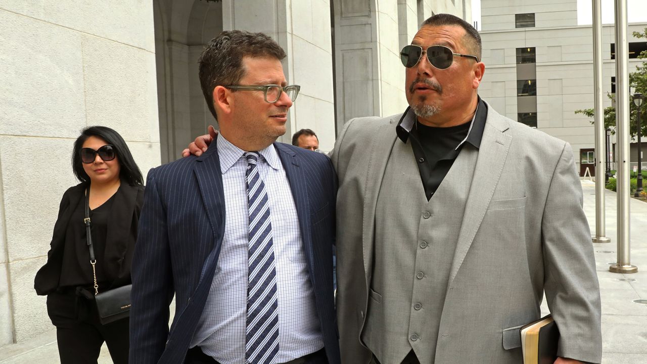 Daniel Saldana, right, leaves the Los Angeles Hall of Justice with his attorney Mike Romano on Thursday.