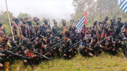 A man who is identified as Philip Mehrtens, the New Zealand pilot who is said to be held hostage by pro-independence group The West Papua National Liberation Army (TPNPB), sits among separatist fighters in Indonesia's Papua region on May 26, 2023.