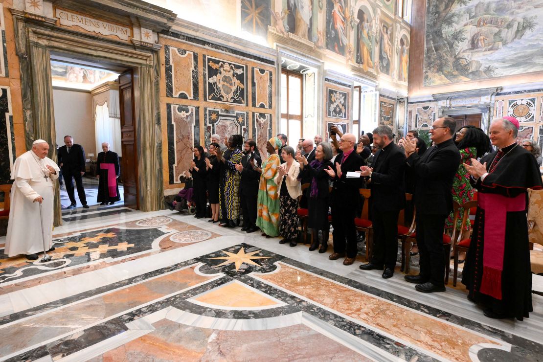 Pope Francis meets with officials during the conference on Saturday. 