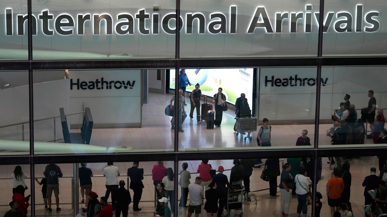 Passengers arrive at Heathrow Airport, in London on Saturday, May 27, 2023. 
