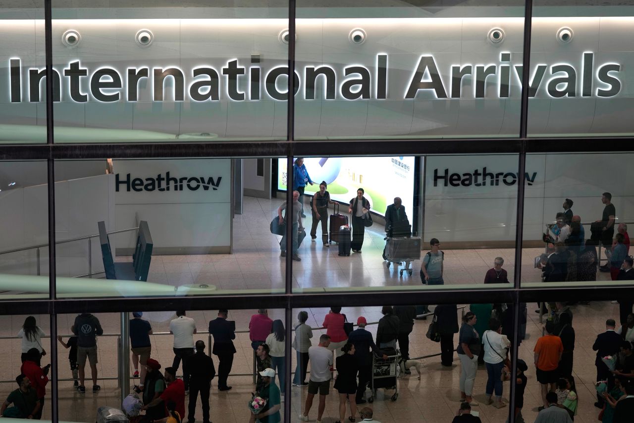 Passengers arrive at Heathrow Airport, in London on Saturday, May 27, 2023. 