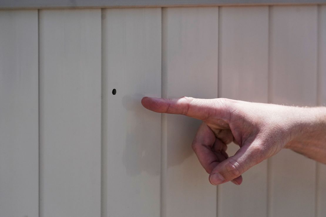 Lane Mugleston, the owner of Leap Ahead Daycare, points to a bullet hole as he speaks to reporters Tuesday, May 23, 2023, in Spanish Fork, Utah.