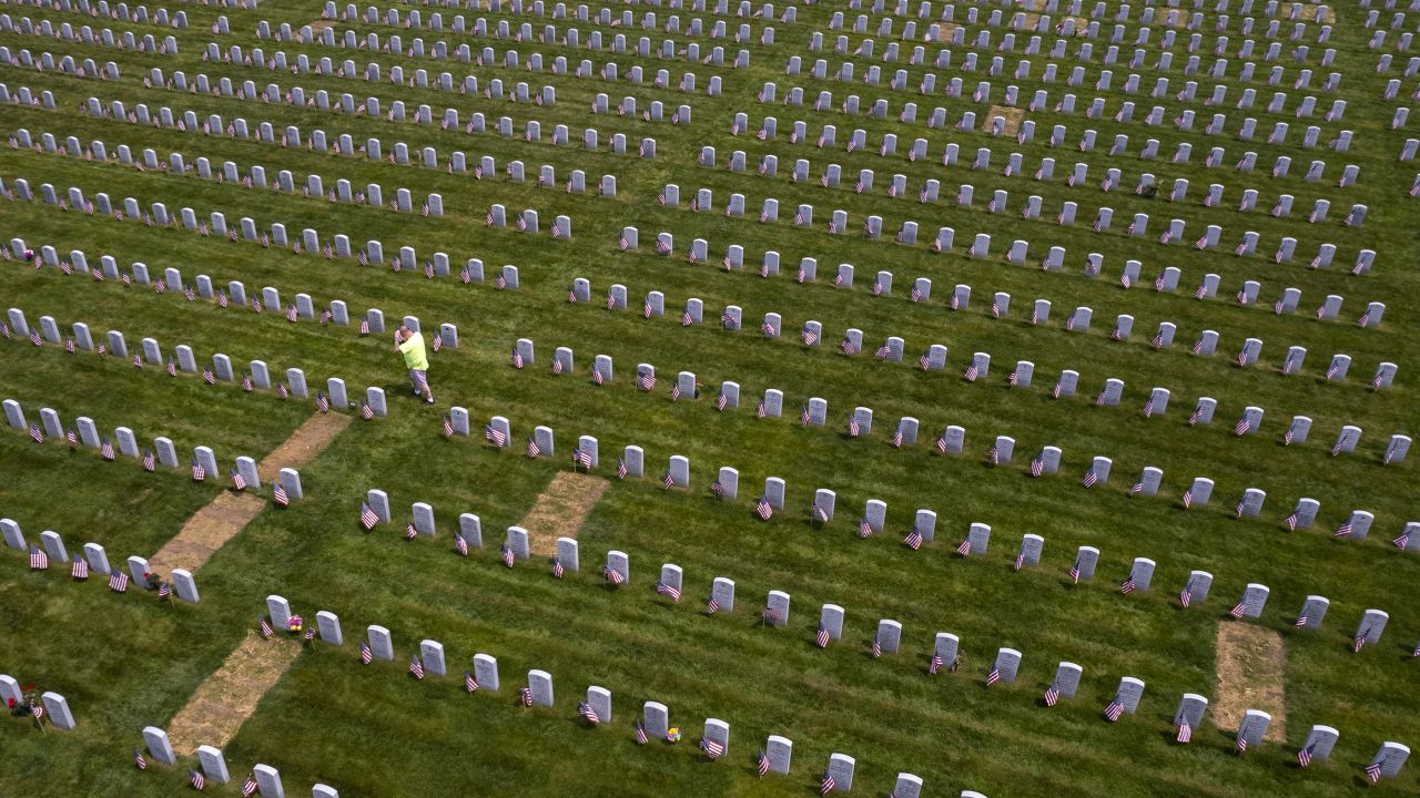 In a photo taken with a drone, a man walks among the grave stones of Veterans and their loved ones after volunteers placed approximately 4,100 American flags at the Massachusetts Veterans Memorial Cemetery in Winchendon, Massachusetts, USA, 24 May 2023. Memorial Day, honoring fallen Veterans, will be celebrated on Monday, 29 May 2023.