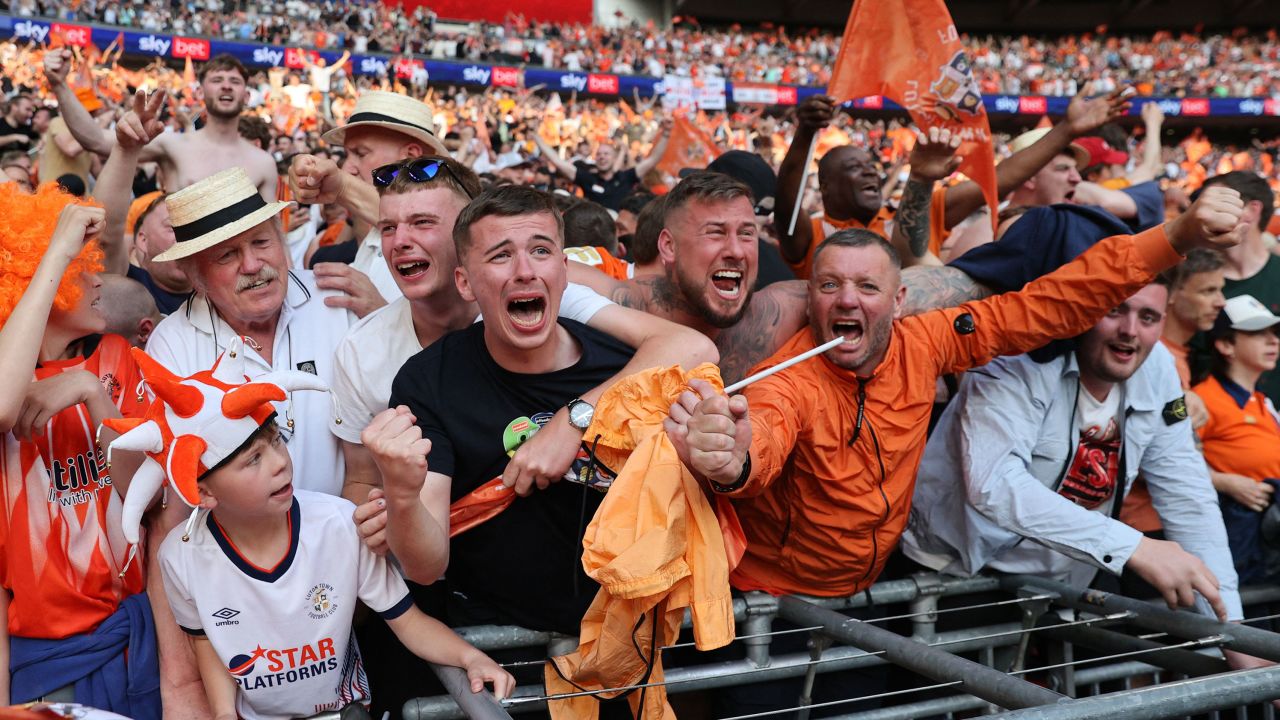 Luton Town's fans celebrate after winning the penalty shootout.