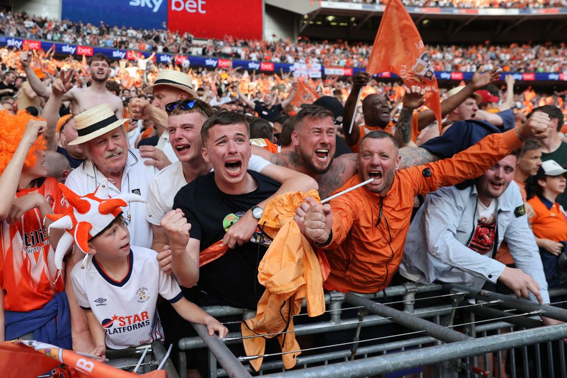 Luton Town's fans celebrate after winning the penalty shootout.