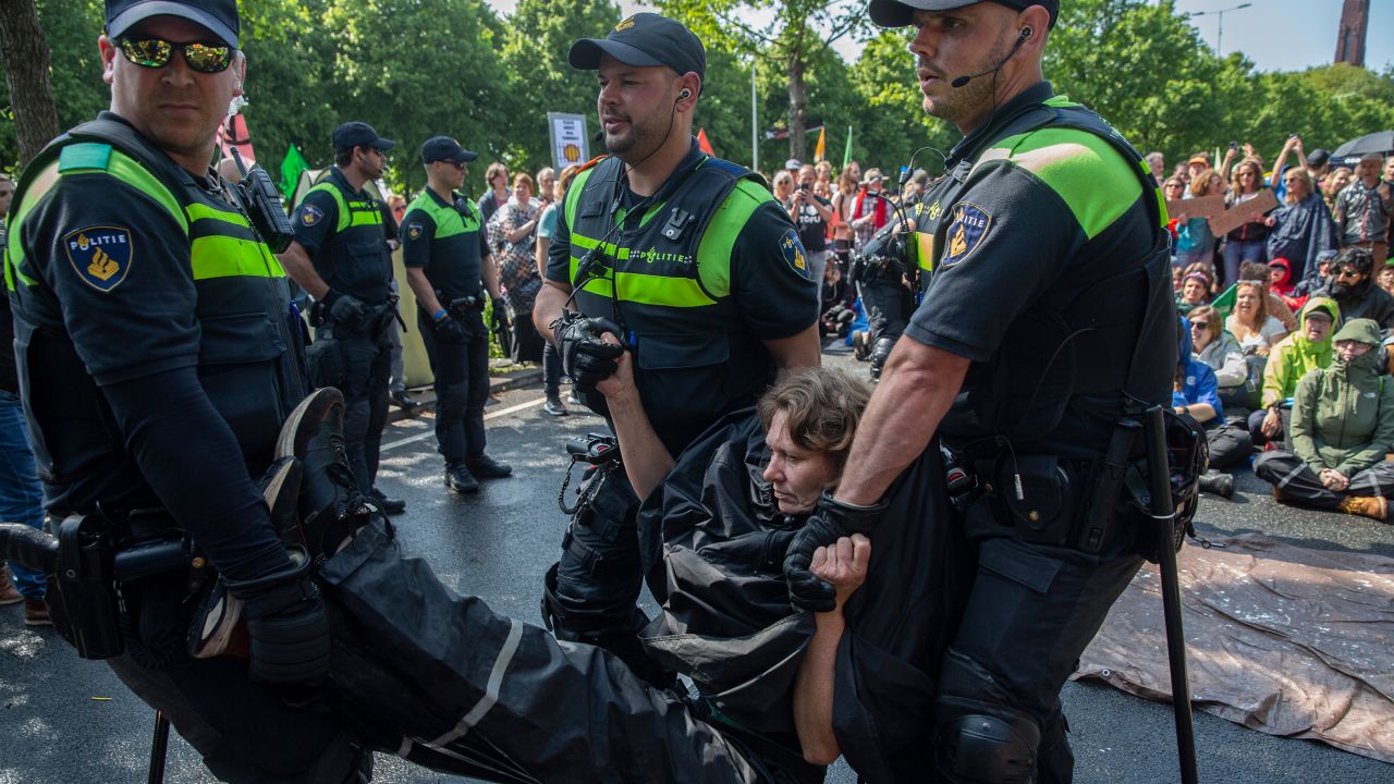 An activists is arrested after blocking the A12 motorway during an Extinction Rebellion led protest to command an end to all fossil fuel subsidies on May 27, 2023 in The Hague, Netherlands. Organisers want among others more honesty about the climate crisis, a stop to biodiversity loss and net zero carbon emissions by 2025. 