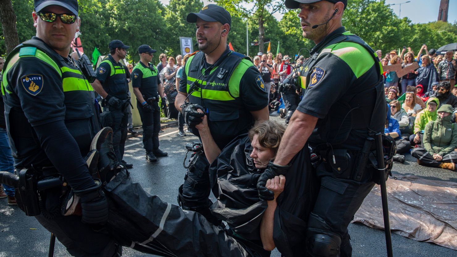 An activists is arrested after blocking the A12 motorway during an Extinction Rebellion led protest to command an end to all fossil fuel subsidies on May 27, 2023 in The Hague, Netherlands. 