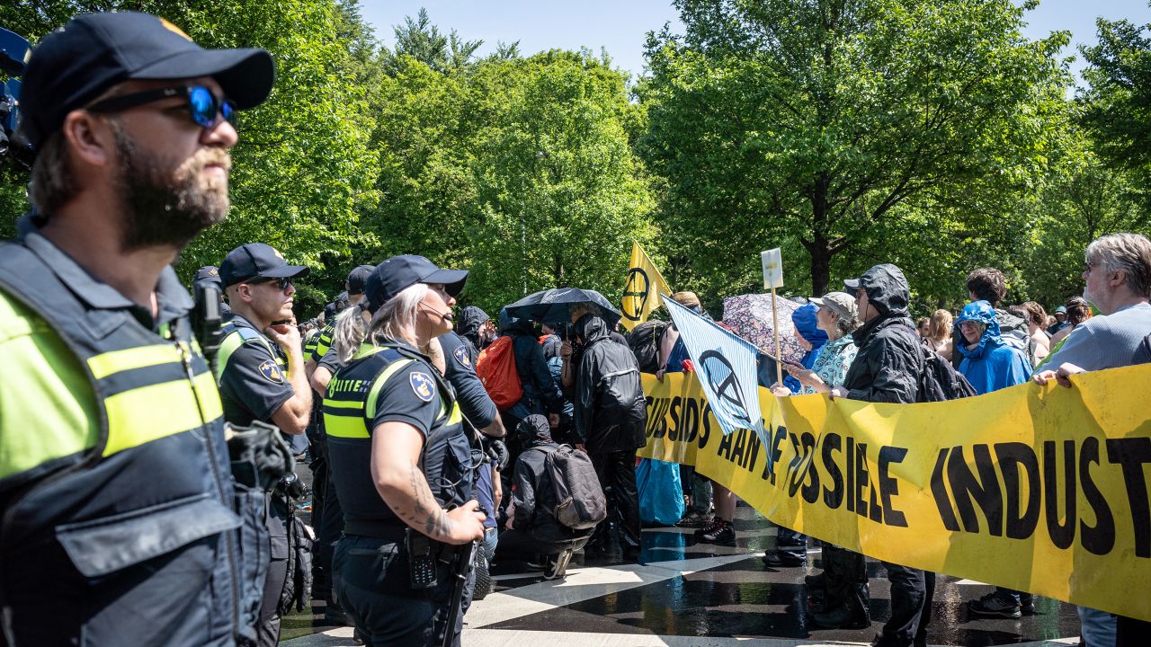 Activists on the highway in front of a police line, in Den Haag, Netherlands, on May 27, 2023. 