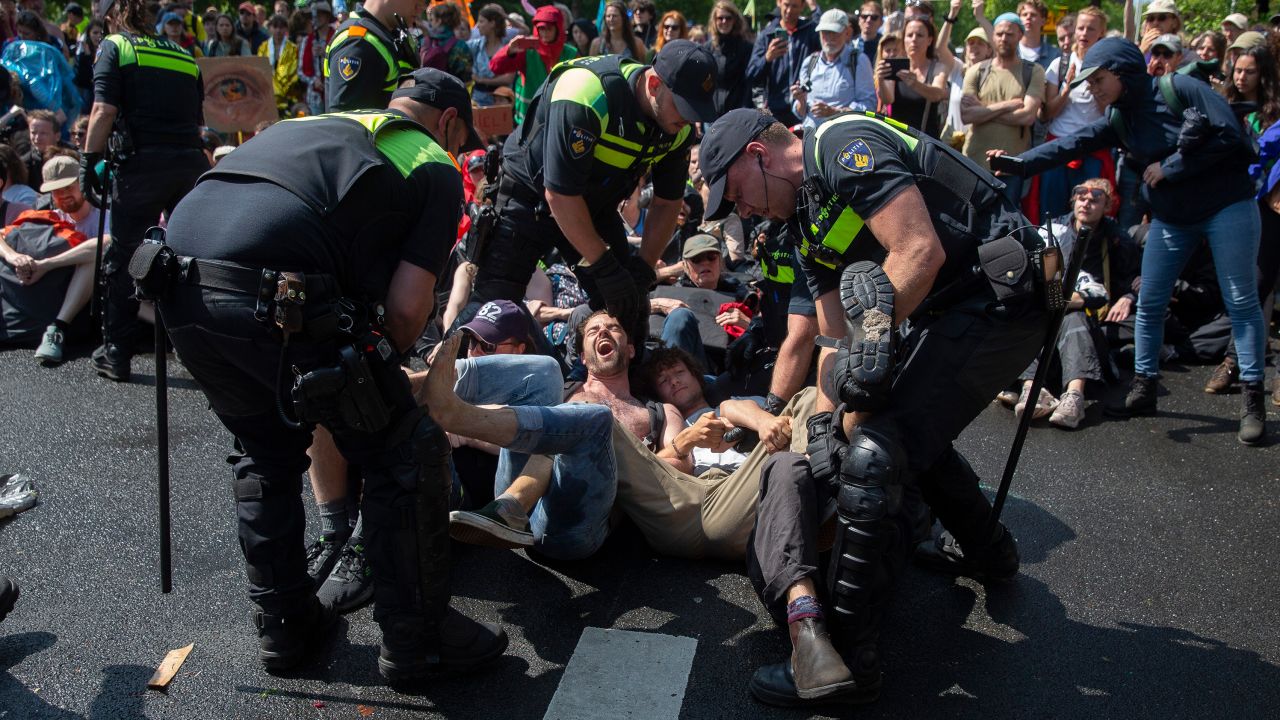 Activists are arrested after blocking the A12 motorway in The Hague.