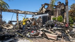 A firefighter puts out hot spots at a house on Coronado Pointe in Laguna Niguel, CA on Thursday, May 12, 2022. The Coastal fire destroyed 20 homes after starting on Wednesday, May 11, in Aliso Woods Canyon. 
