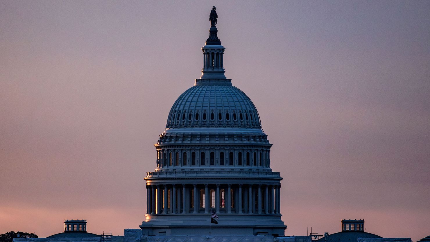 The US Capitol building is seen from the base of the Washington Monument as the sun rises in Washington, DC, on May 28, 2023. 