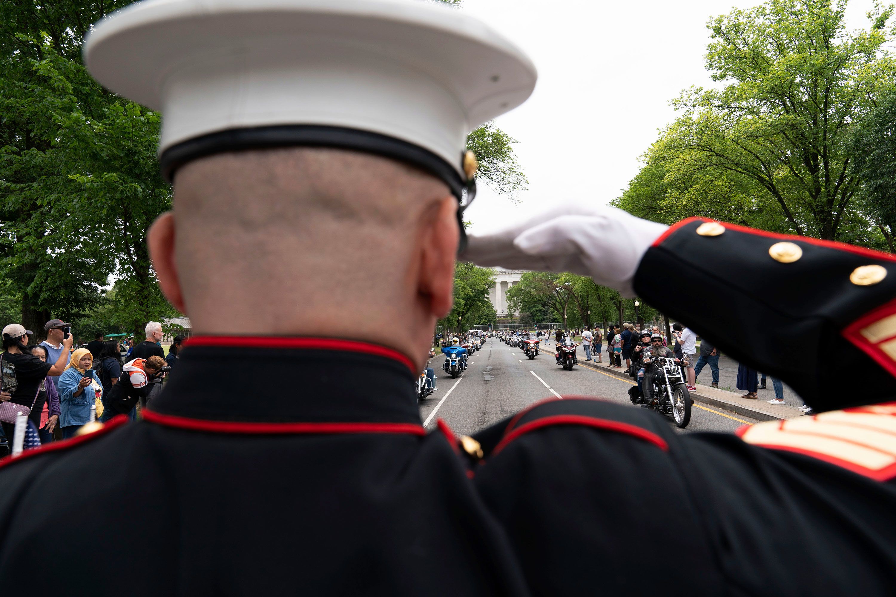 Marine Corps Staff Sgt. Tim Chambers salutes Sunday as people ride past him during the 'Rolling to Remember' motorcycle rally in Washington, DC.