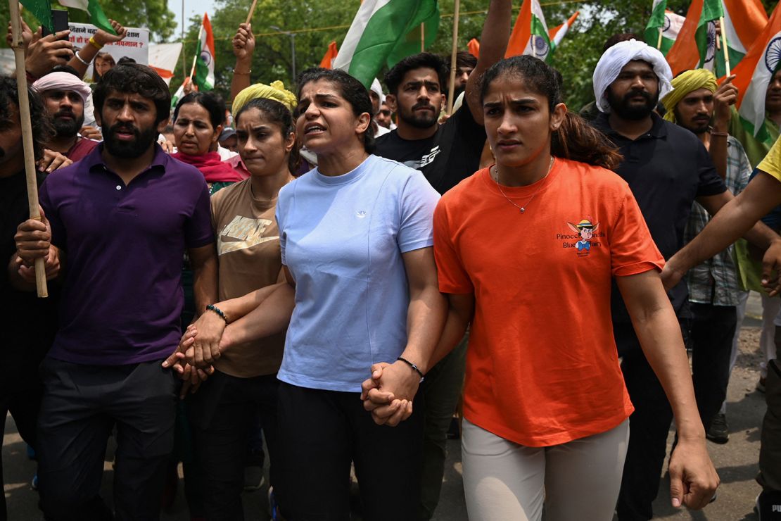 Indian wrestlers Bajrang Punia (L), Vinesh Phogat (2nd L), Sakshi Malik (2nd R) and Sangeeta Phogat (L) attempt to march to India's new parliament during a protest against Brij Bhushan Singh over allegations of sexual harassment, in New Delhi on May 28, 2023. 