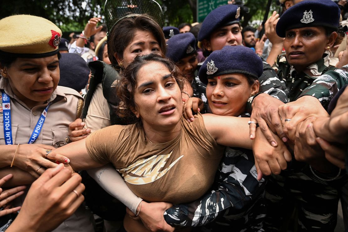 Indian wrestler Vinesh Phogat is detained by the police while attempting to march to India's new parliament in New Delhi on May 28, 2023. 