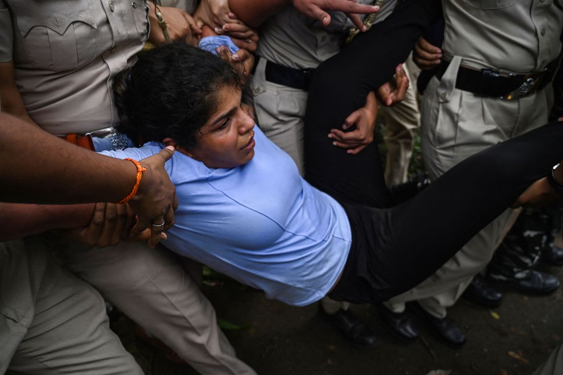 Indian wrestler Sakshi Malik is detained by the police while attempting to march to India's new parliament in New Delhi on May 28, 2023. 