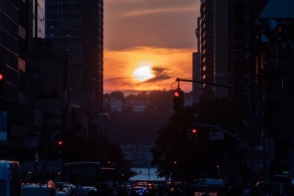 The sun sets while lined up with 42nd Street, after the Manhattanhenge phenomenon, in the Manhattan borough of New York City on July 11, 2022.