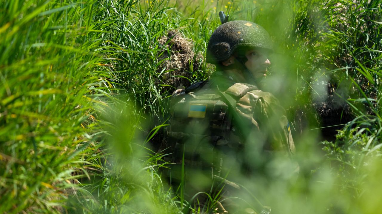 Ukrainian soldiers secure positions inside an enemy trench during a drill designed to emulate the type of combat operations seen in the country's east.