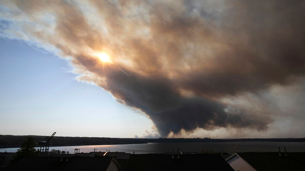 Thick plumes of smoke fill the sky as an out-of-control fire in a suburban community quickly spreads, engulfing multiple homes and forcing the evacuation of residents, in Halifax, Nova Scotia, on May 28.
