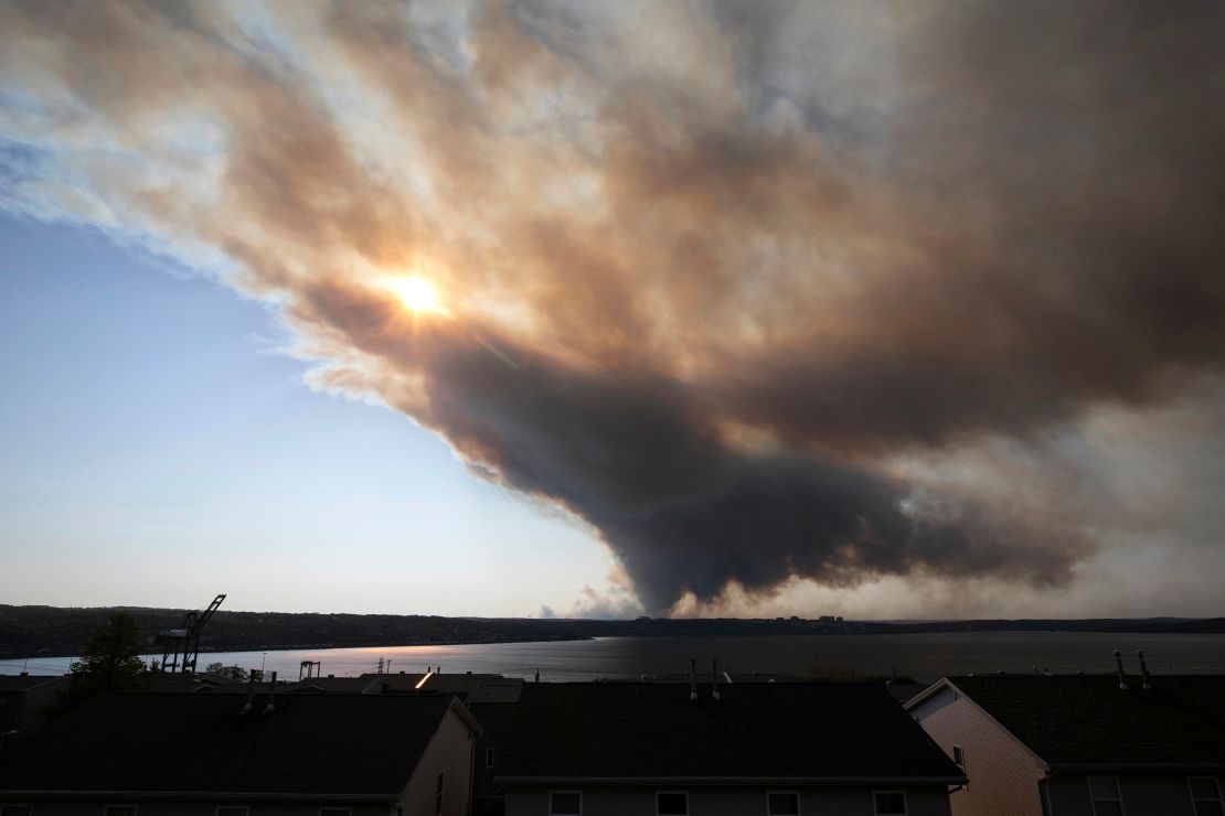Thick plumes of smoke fill the sky as an out-of-control fire in a suburban community quickly spreads, engulfing multiple homes and forcing the evacuation of residents, in Halifax, Nova Scotia, on May 28.
