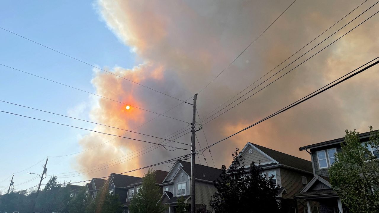 Smoke from the Tantallon wildfire rises over houses in nearby Bedford, Nova Scotia, on May 28.