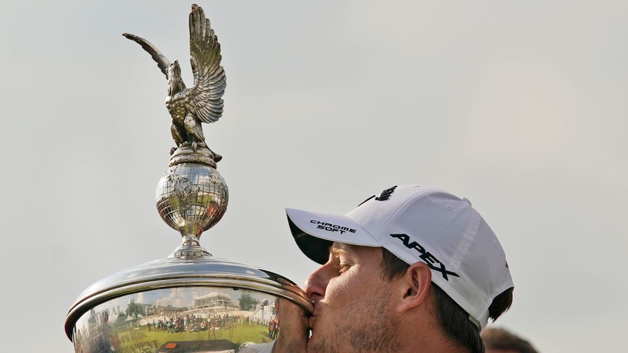 Emiliano Grillo, of Argentina, kisses the trophy after winning the Charles Schwab Challenge golf tournament at Colonial Country Club in Fort Worth, Texas, Sunday, May 28, 2023.
