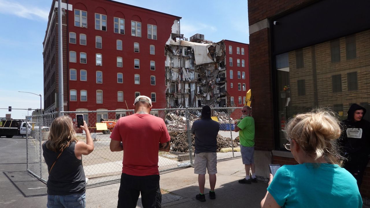 Bystanders look at the remains of a partially collapsed apartment building Monday in Davenport, Iowa.
