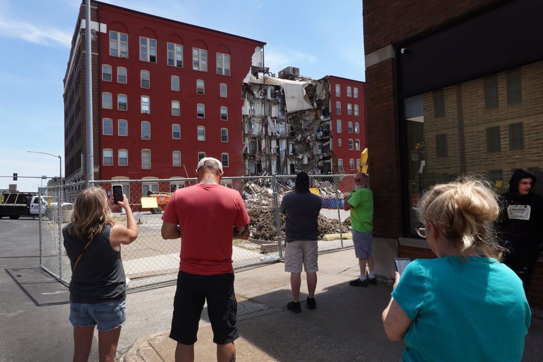 Bystanders look at the remains of a partially collapsed apartment building Monday in Davenport, Iowa.