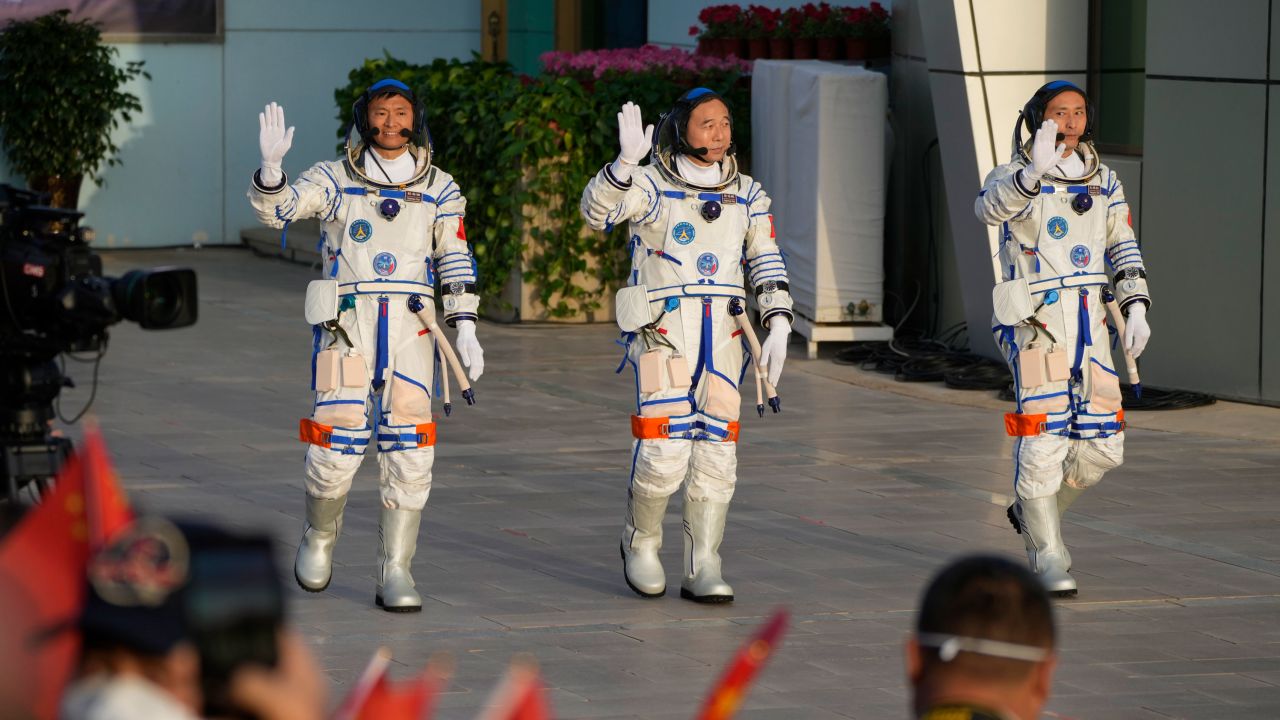 Chinese astronauts for the Shenzhou-16 mission, from left, Gui Haichao, Jing Haipeng and Zhu Yangzhu wave as they arrive for a send-off ceremony ahead of their manned space mission at the Jiuquan Satellite Launch Center in northwestern China on May 30, 2023. 