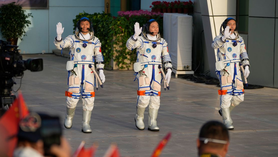 Chinese astronauts for the Shenzhou-16 mission, from left, Gui Haichao, Jing Haipeng and Zhu Yangzhu wave as they arrive for a send-off ceremony ahead of their manned space mission at the Jiuquan Satellite Launch Center in northwestern China on May 30, 2023. 