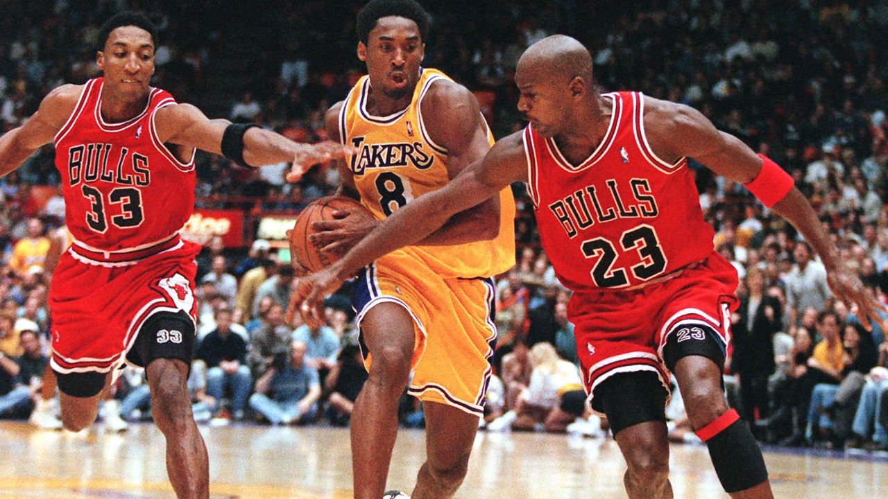Pippen and Jordan try to stop Kobe Bryant in a game in February 1998.