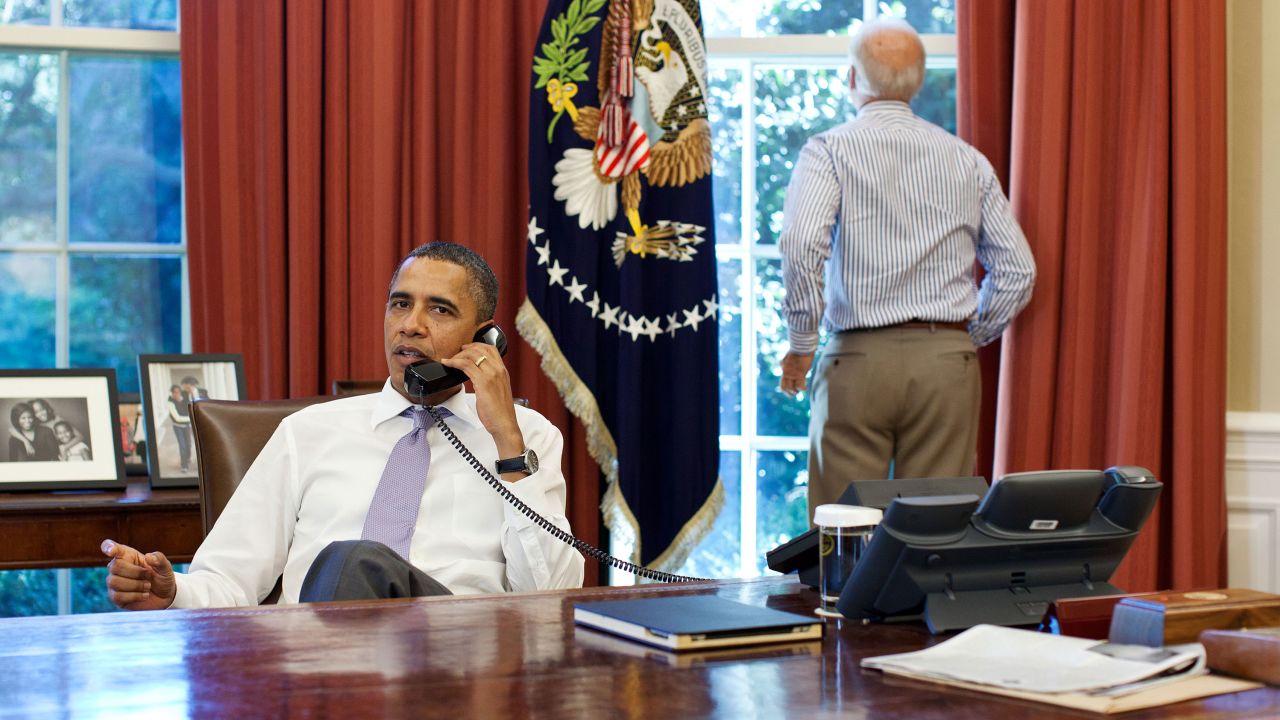 WASHINGTON - JULY 31: In this handout provided by the White House, Vice President Joe Biden (R) looks out the window as U.S. President Barack Obama talks on the phone with House Speaker John Boehner in the Oval Office to discuss ongoing efforts in the debt limit and deficit reduction talks July 31, 2011 in Washington, DC. Obama announced that congressional leaders had reached a tentative agreement to extend the federal debt limit while enacting spending cuts.  (Photo by Pete Souza/The White House via Getty Images)
