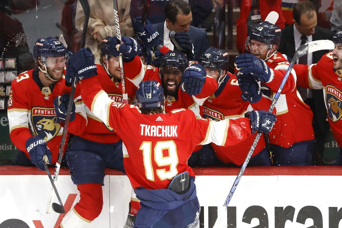 Tkachuk celebrates with his teammates after scoring the game-winning goal against the Carolina Hurricanes.