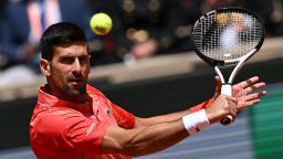 Serbia's Novak Djokovic plays a backhand return to US Aleksandar Kovacevic during their men's singles match on day two of the Roland-Garros Open tennis tournament at the Court Philippe-Chatrier in Paris on May 29, 2023. (Photo by Emmanuel DUNAND / AFP) (Photo by EMMANUEL DUNAND/AFP via Getty Images)